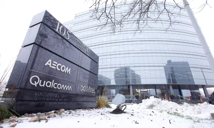 Exterior of 105 Commerce Valley Dr West with snow on the ground (Sign with logos of AECOM, Qualcomm, and Mitel)